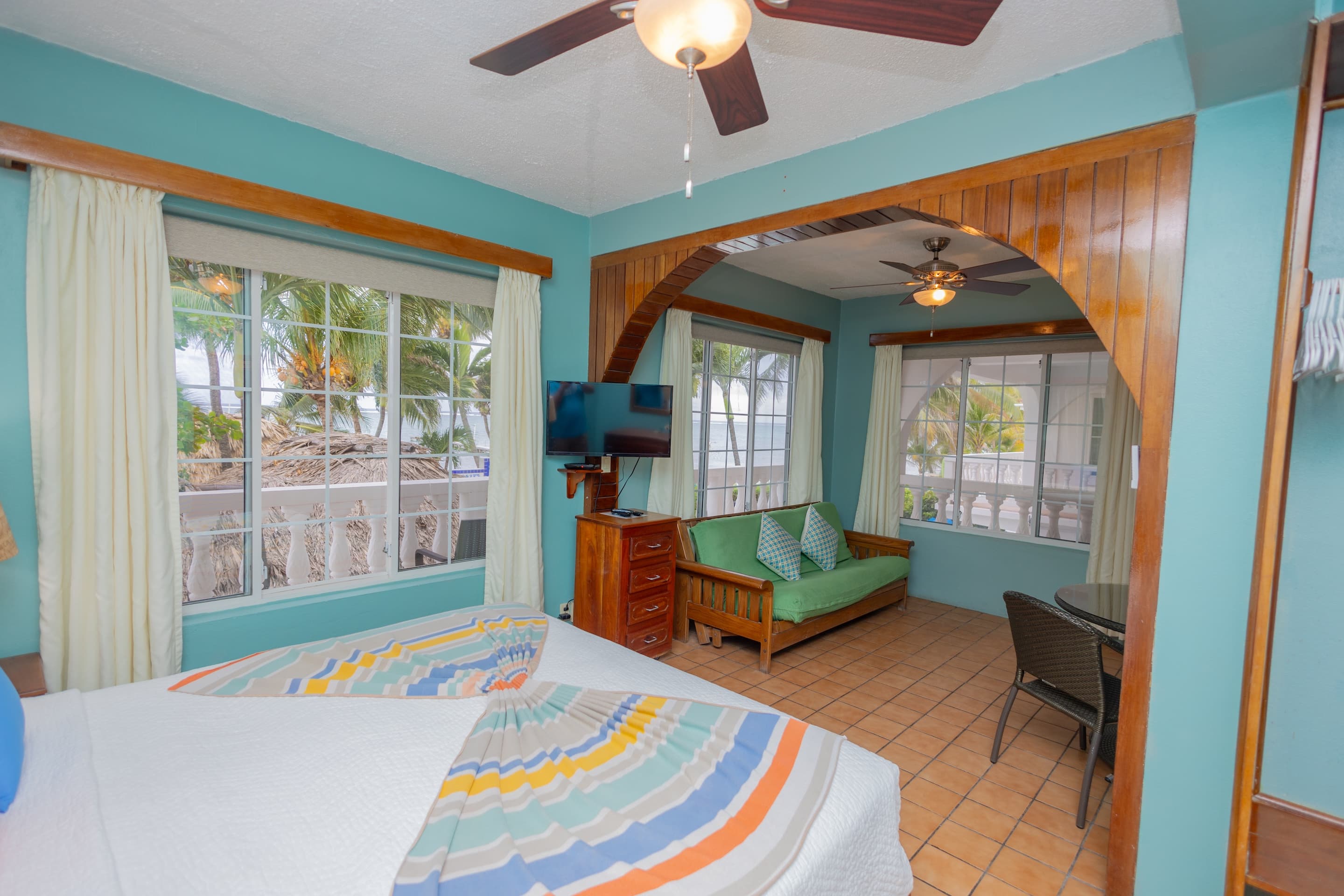 Suite with king bed, futon, large windows with ocean view