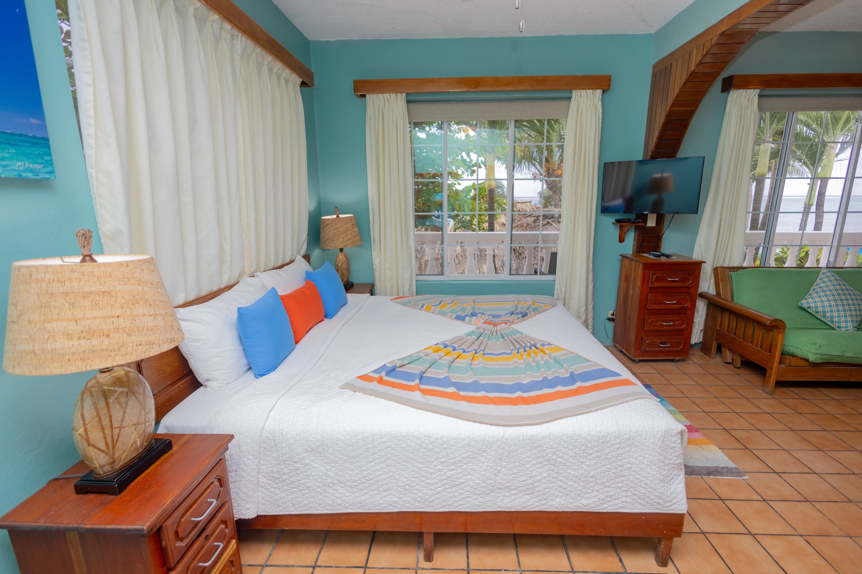 Suite with king bed, futon, large windows with ocean view