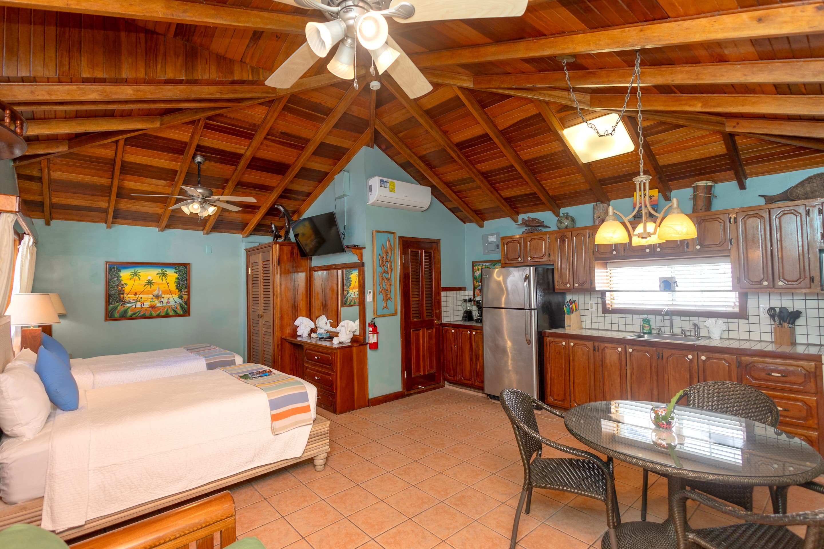 Studio Suite with wood floors and ceilings, 2 Double beds, futon, dresser, kitchen and large Armoir