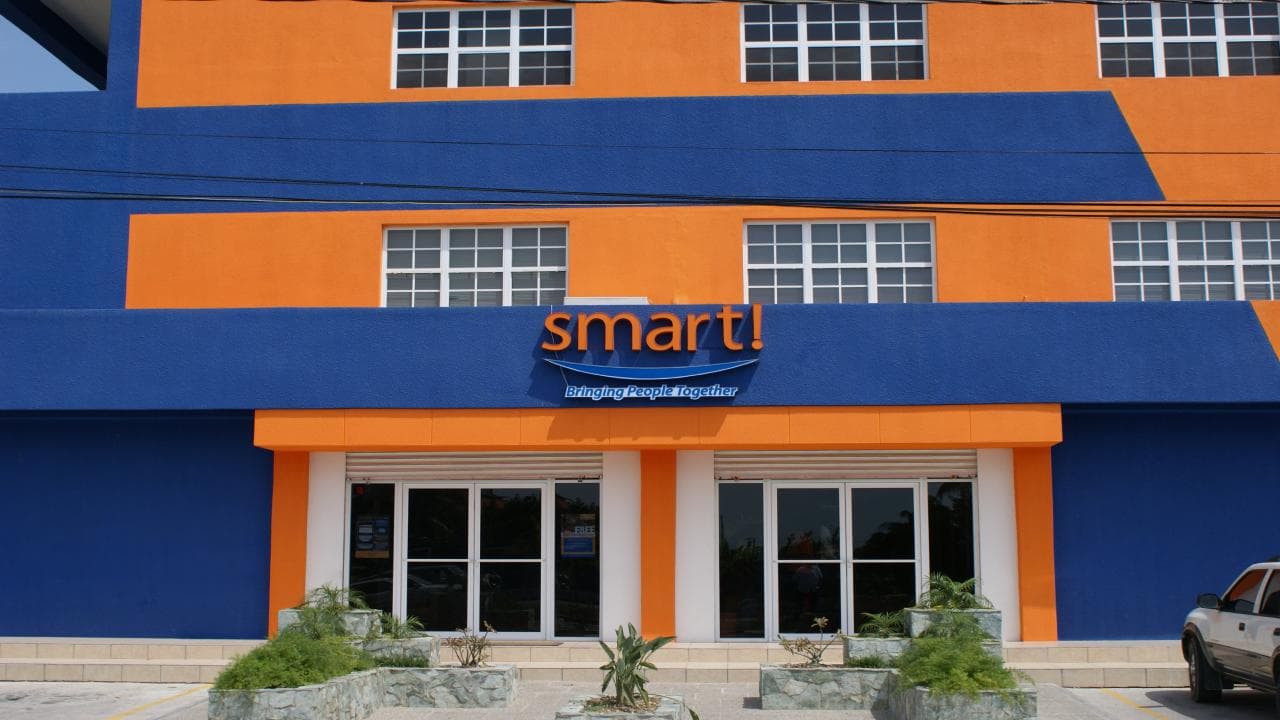 Brightly colored blue and orange building with a sign that reads "smart!" above the entrance.